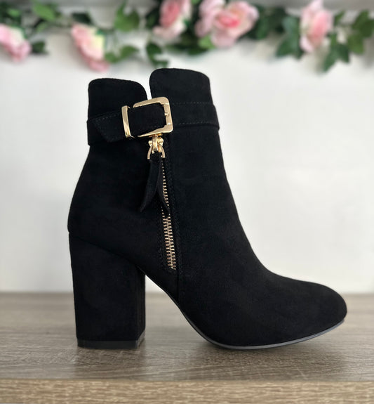 Black suede heeled boots with gold zip and buckle detail