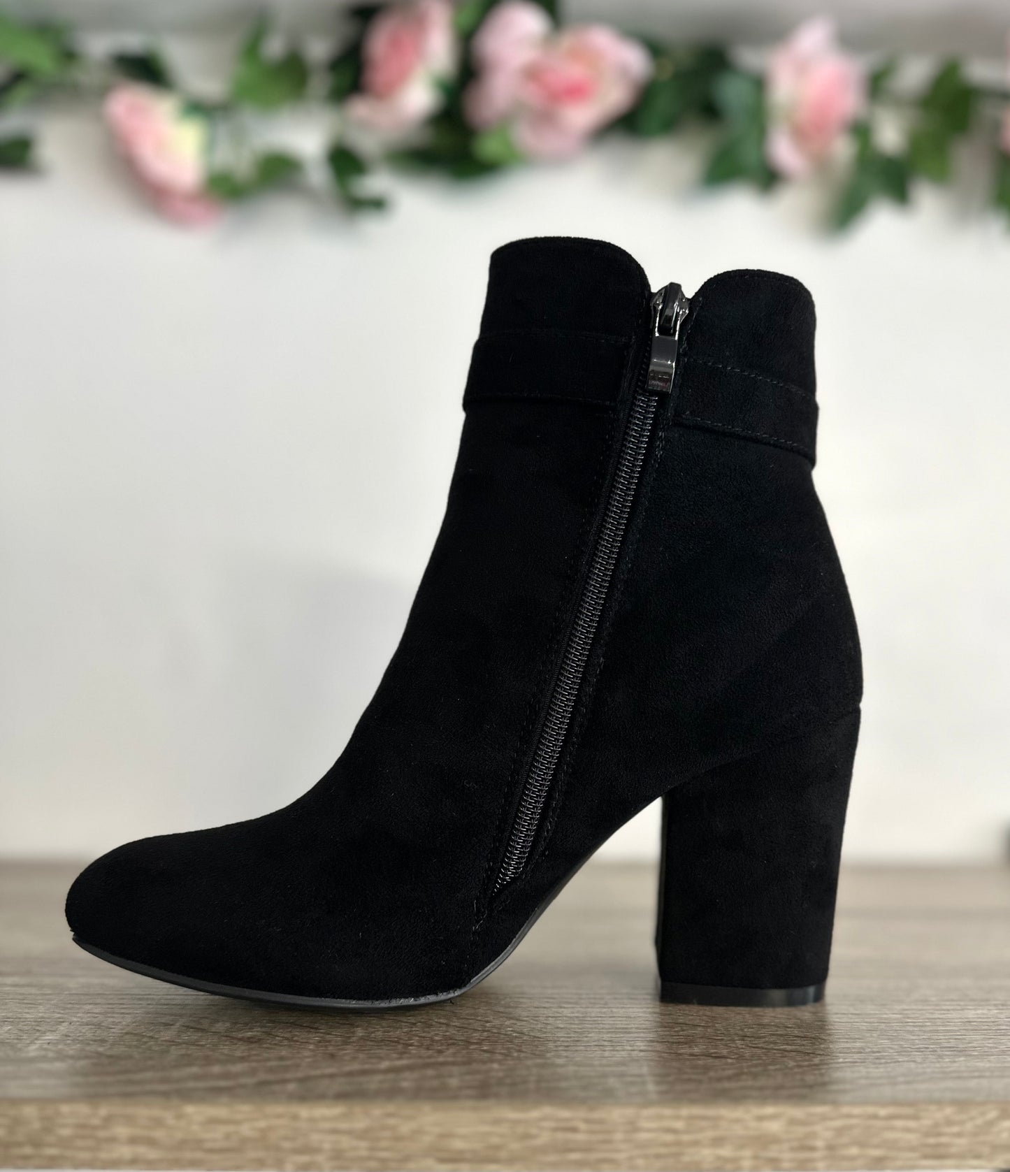 Black suede heeled boots with gold zip and buckle detail