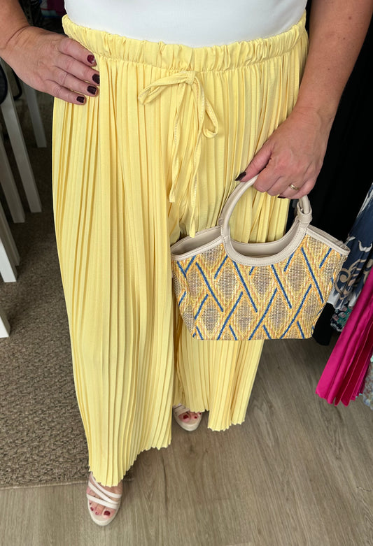 Yellow pleated wide leg trousers